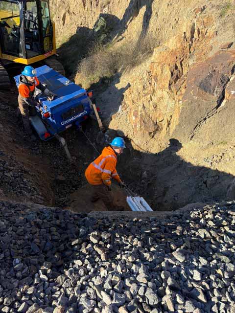 Damaged pipeline being repaired via trenchless procedure